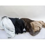 A Motorlux car rug in black and grey with reversible fake fur, together with another similar in
