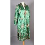 A 1930s Chinese emerald green silk robe embroidered and trimmed in coral and ivory