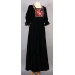 A black velvet full length evening dress with floral printed chiffon bodice, short puff sleeves,