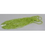A multi strand necklace of facetted peridot beads with silver fittings, boxed, approximate width