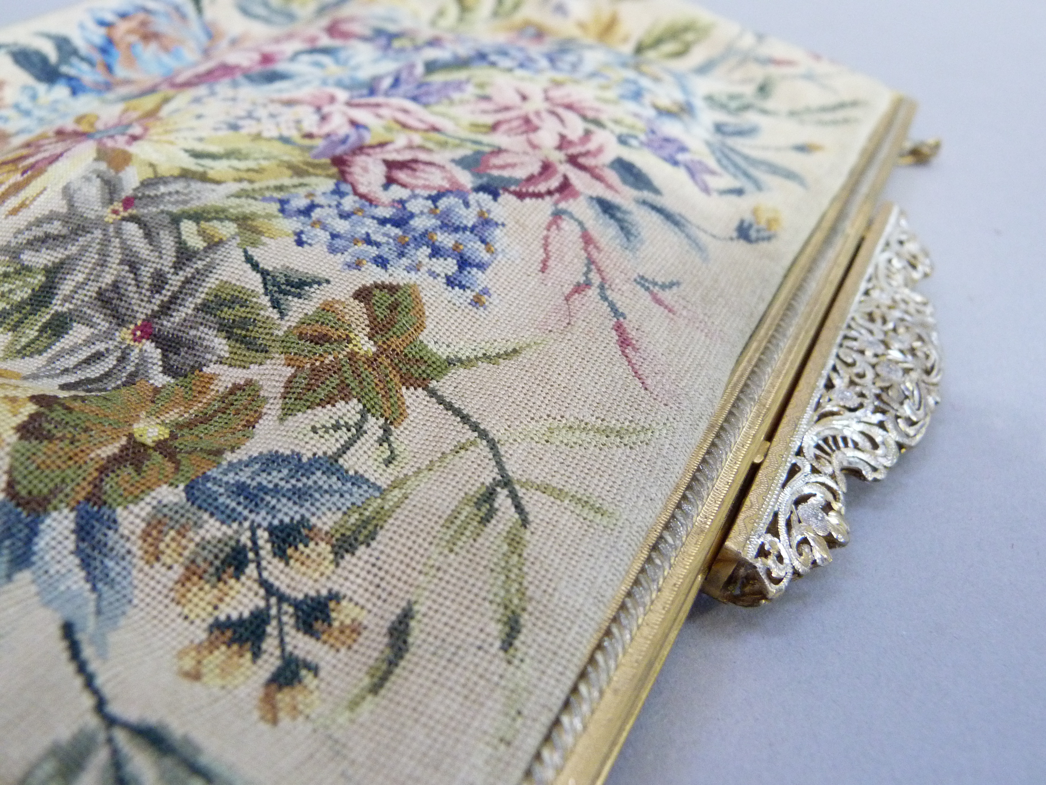 A Petit Point evening bag, of floral design, gilt metal frame, pierced clasp and gilt metal chain,