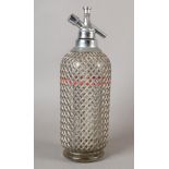 A Vintage soda syphon with wire wrapped body and chromium plated mounts, 34cm high, together with