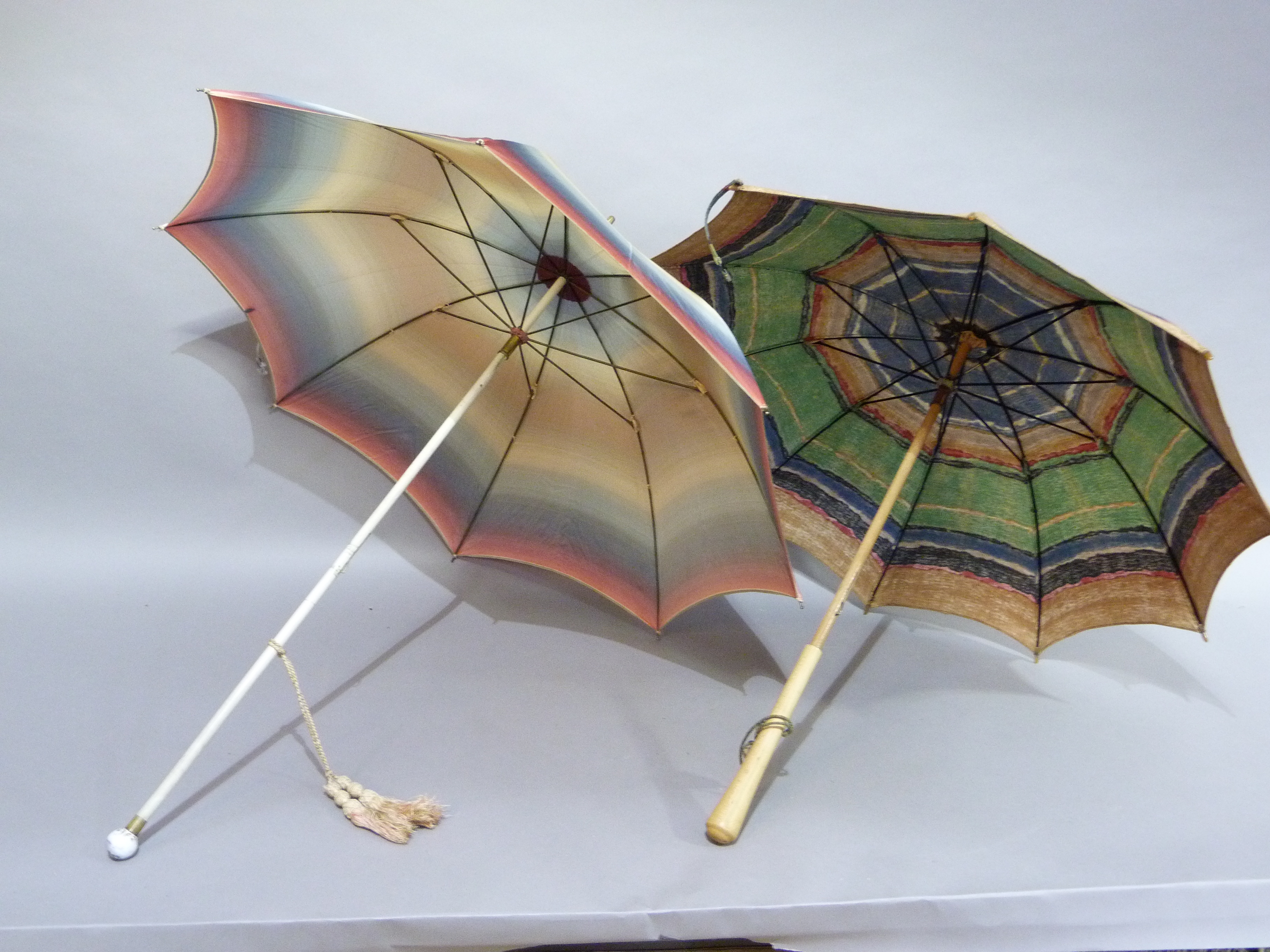 A vintage rainbow coloured rayon parasol, the cream shaft with spherical finial painted with a