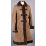 A lady's vintage A-Line sheepskin coat size 14, fur collar and trim, with frogging and slit