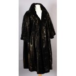 Marshall and Snelgrove, a lady's three quarter evening coat, black with copper undertones