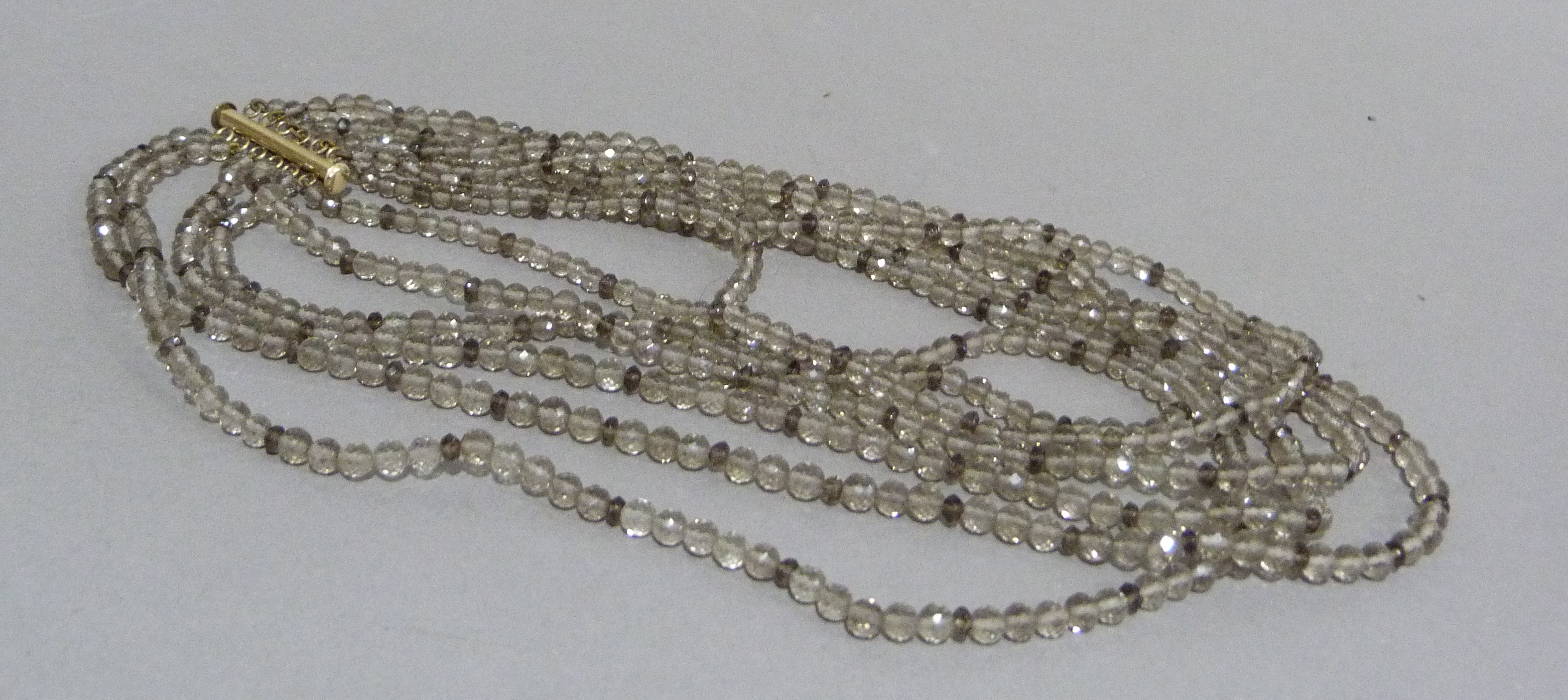 A multi strand necklace of graduated facetted smoky quartz beads with rolled gold fittings, - Image 3 of 3