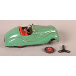 A Schuco Examico 4001 clockwork tin plate car, green livery with red interior, with a key, 14cm long