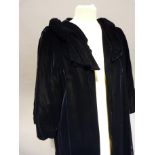 A black velvet evening coat with three quarter sleeves