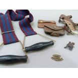 A pair of nickel plated stirrups, a vintage leather purse, a leather wallet of steel instruments, an