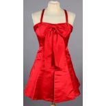 Gemma Kahng, New York, a red satin sleeveless cocktail dress with bow detail