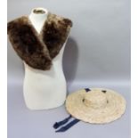 A ladies vintage broad brimmed straw sun hat with low crown, black bow and ribbon fastening and a