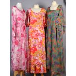 Three maxi dresses circa 1960's including a floral printed maxi dress in orange yellow pink and