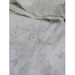 A pair of white embroidered single sheets, a pair of bolster cases and a pillow case, with scalloped