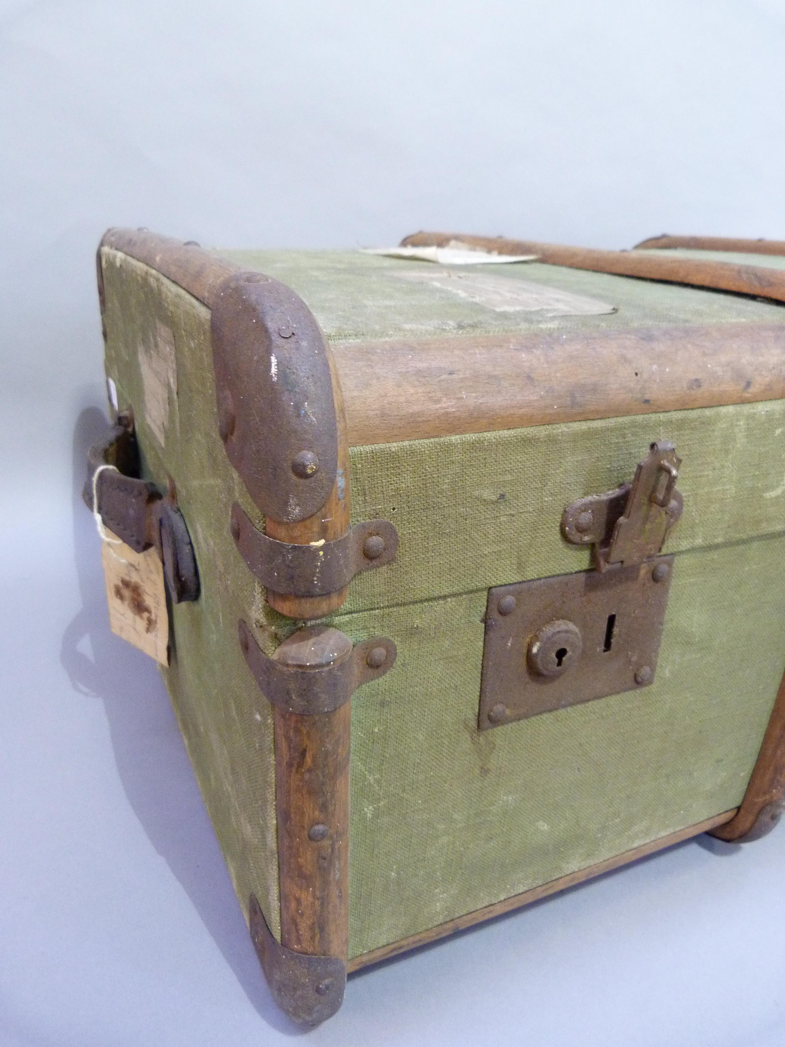 A canvas trunk with wood ribbing with luggage labels 'Luggage in Advance' 85cm wide x 52cm deep x