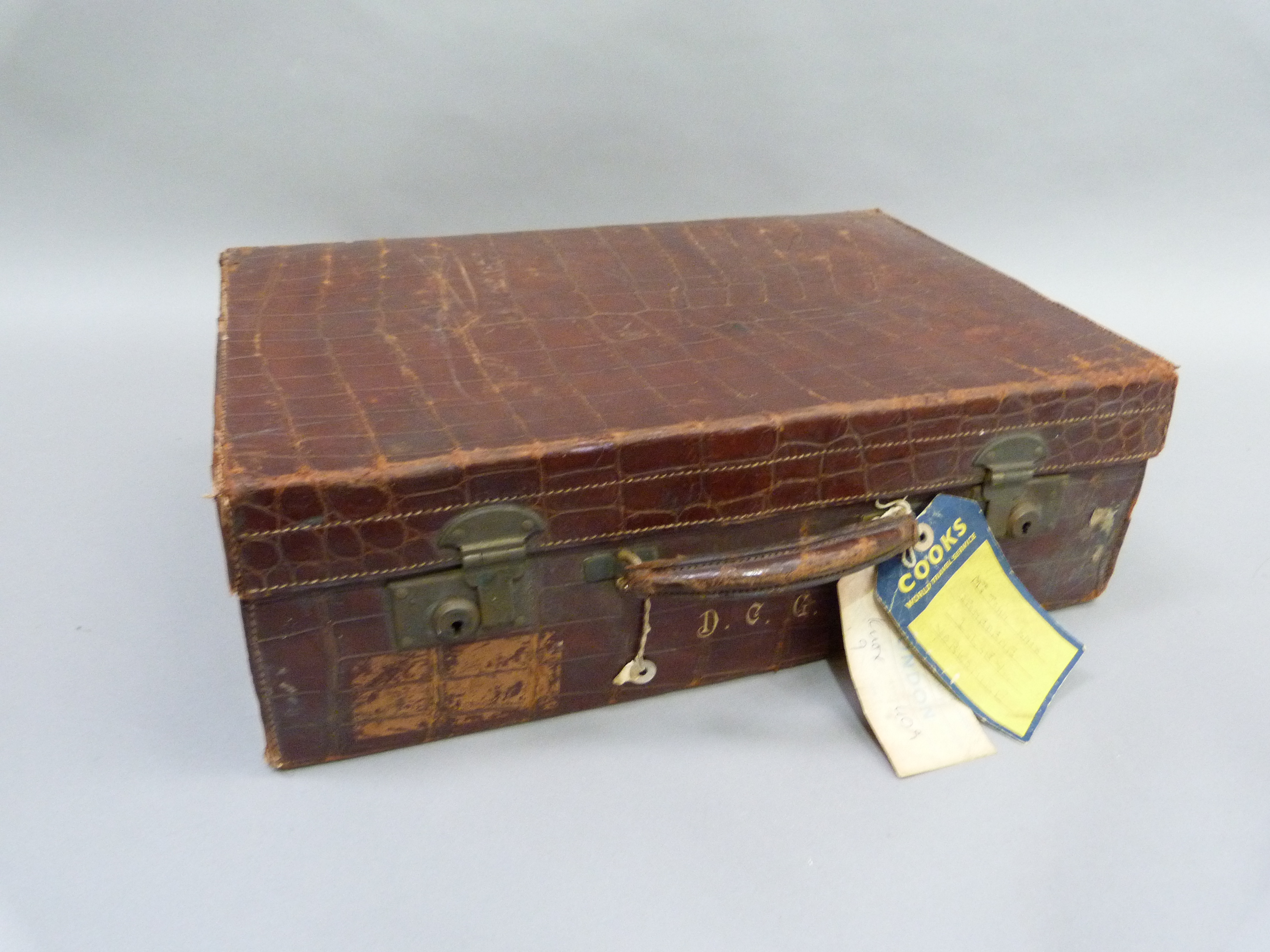 An early 20th century crocodile skin suitcase by Arthur Barber of Bradford, the interior lined in