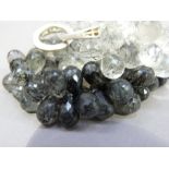 A necklace of rutilated quartz graduated in colour and size brilloetes with silver fastener,