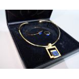 A suite of torq necklace, ring and bangle by J.M Forge in gilt set with simulated lapis lazuli,