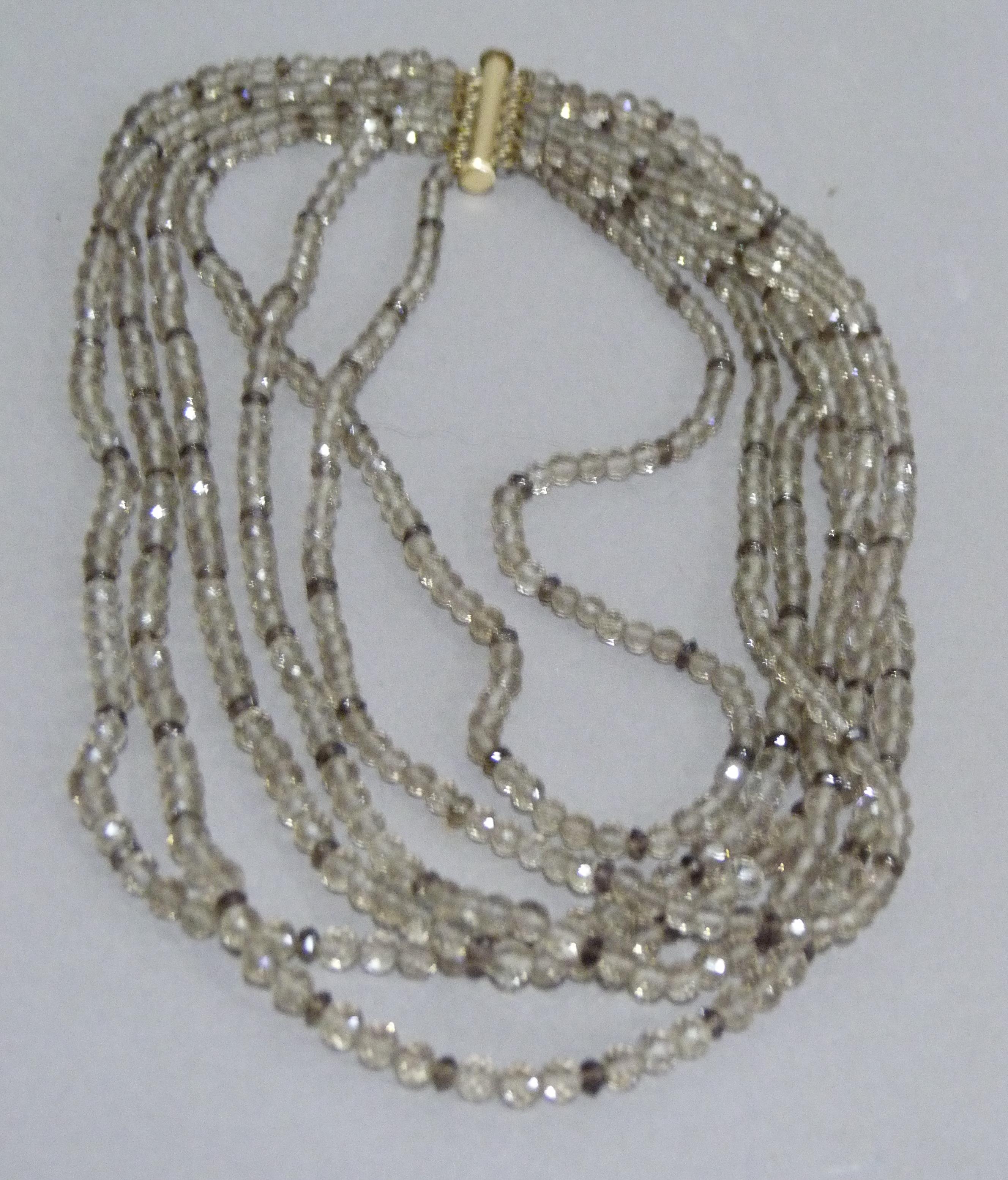 A multi strand necklace of graduated facetted smoky quartz beads with rolled gold fittings,