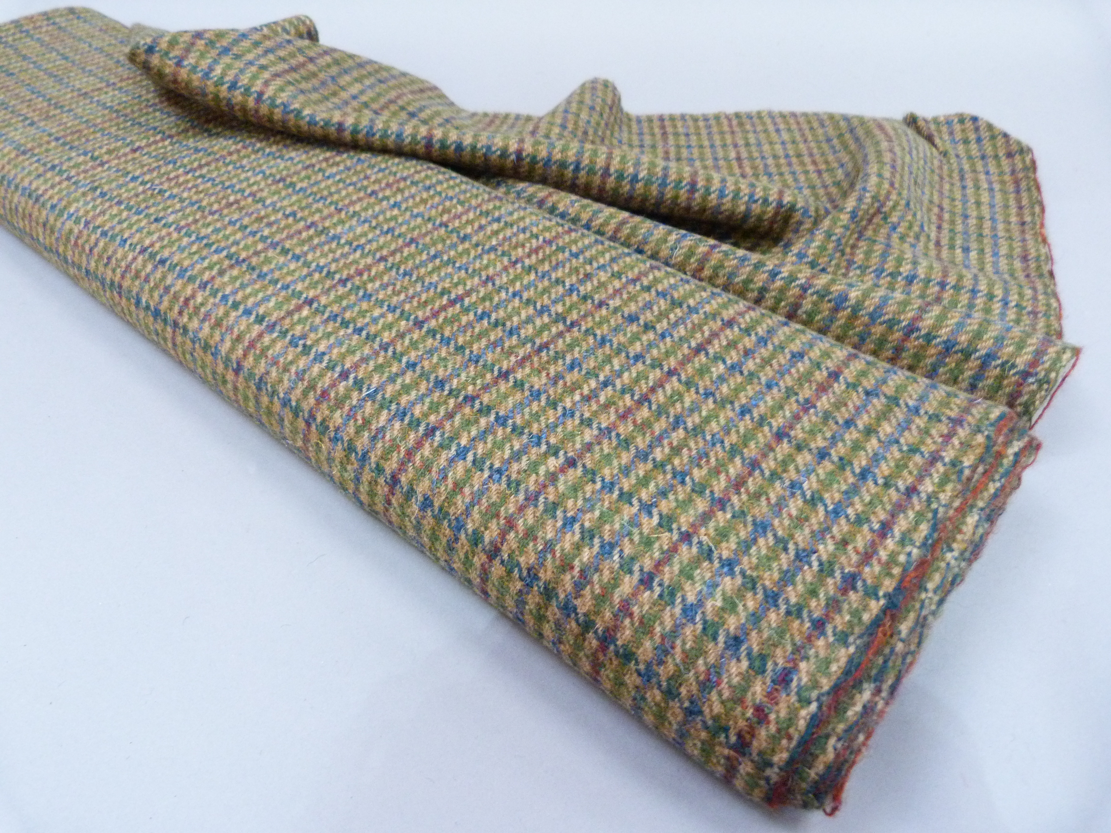 A length of Harris Tweed in blue, red and green stripe on camel ground