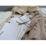 A quantity of table linens including tablecloth and napkin sets, place mats, napkins, ecru