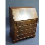 A reproduction mahogany bureau in George III style the figured fall flap with cross grained border