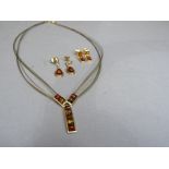 A necklace and earrings suite set with Baltic amber, each square cabouchon channel set in yellow