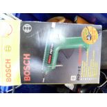 A Bosch PKP18e electronic glue gun pistol together with a quantity of glue gun rods, clamps and