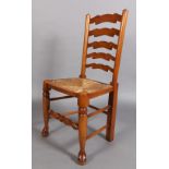 A reproduction elm ladder back dining chair with rush seat