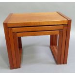 A nest of three teak tables, 60cm wide and smaller