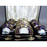 A set of six Hammersley china tea cups and saucers decorated in dark blue and gilt on a white