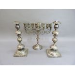 A silver plated Menorah, 13.5cm high, together with a pair of double baluster candlesticks with