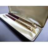 A Parker set of yellow metal and maroon fountain pen and retractable pencil, the lids stamped 12ct