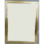 A reproduction wall mirror with giltwood cavetto moulded frame, bevelled rectangular plate, 136cm