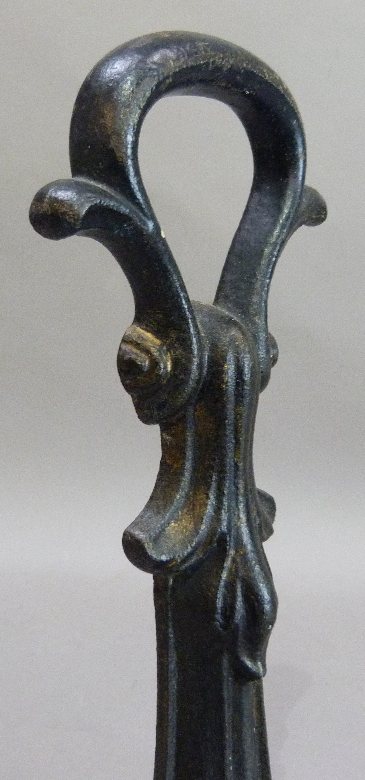 A Victorian cast iron door porter with loop handle and of leaf form, 32cm high