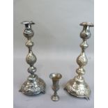 A pair of silver candlesticks, double baluster form on a circular domed base, embossed with border