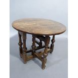 A good reproduction oak small drop leaf gate leg coffee table in late 17th century style, the oval
