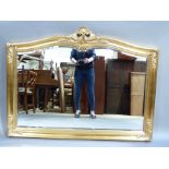 A reproduction gilt framed over mantel mirror with pierced foliate cresting, moulded frame with