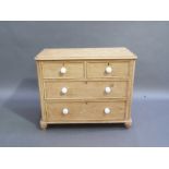 A Victorian stripped pine chest of two short over two long graduated panelled drawers, flanked by