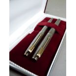 A Parker sterling silver cased fountain pen and biro in original box