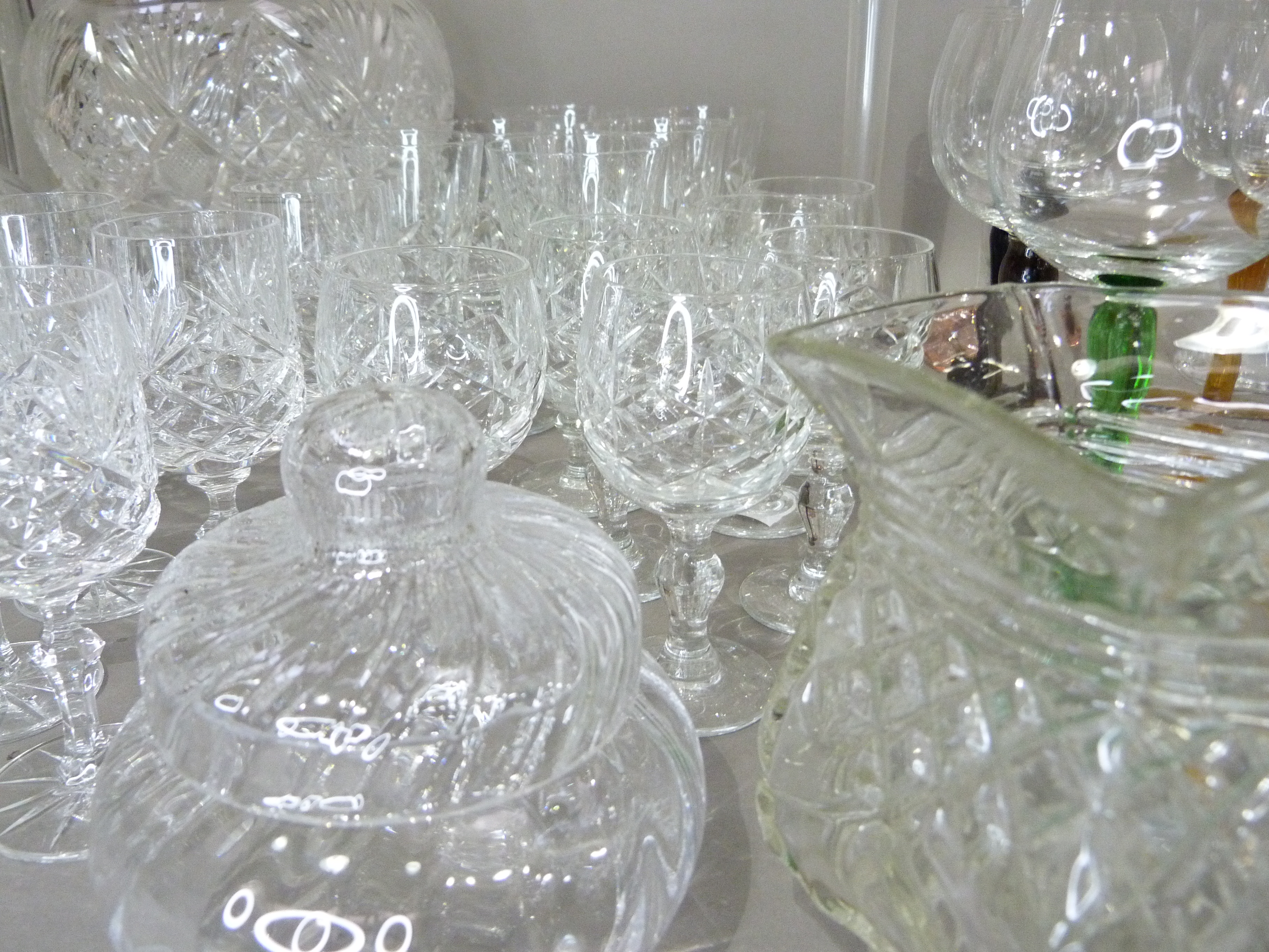 A quantity of cut and plain glassware including harlequin hocks, cut glass rose bowl, vases etc