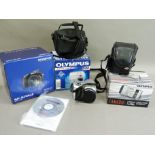 A series of Olympus digital cameras with cases and original packaging