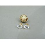 A pair of cubic zirconia ear studs and a polychrome enamel ear enhancer both in yellow metal (