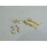 Three pairs of earrings all in 9ct gold variously set with blue topaz and cubic zirconia (at