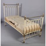 A Victorian brass and cast iron single bedstead retailed by Heals, metal decal to end rail, of