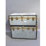 Two tin trunks with lacquered brass and black plastic borders and corners, both 91cm wide, one