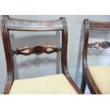 A pair of Regency mahogany dining chairs with reeded, moulded rails, the figured concave