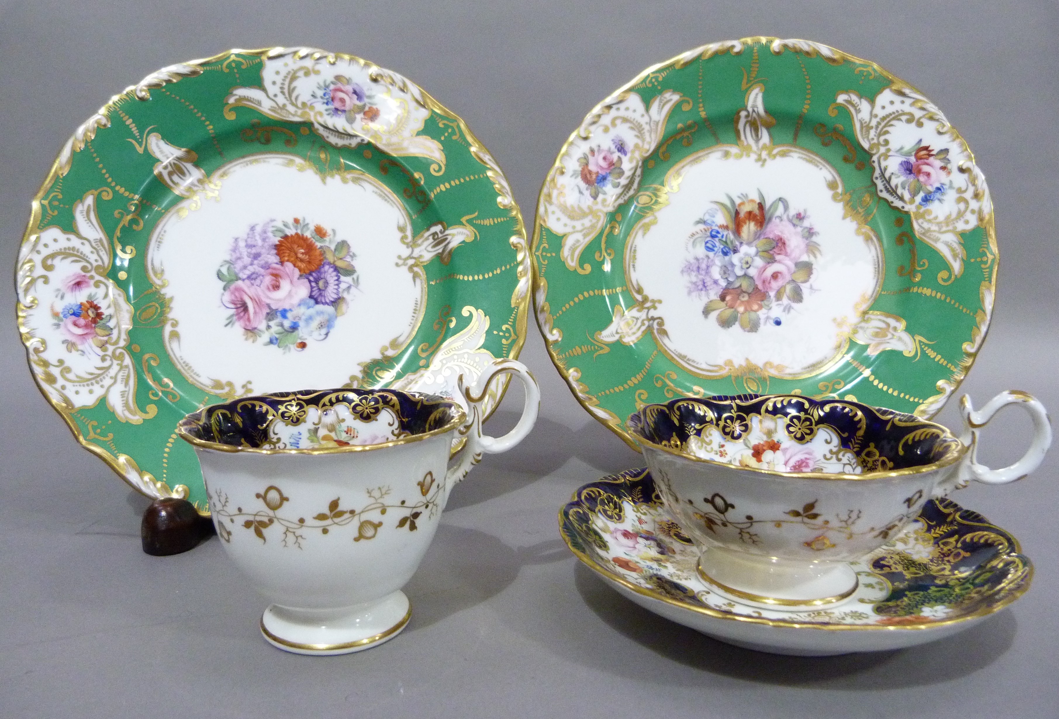 A mid nineteenth century English china trio of two cups and saucer, polychrome enamelled with sprays