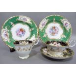 A mid nineteenth century English china trio of two cups and saucer, polychrome enamelled with sprays