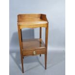 A George III mahogany two tier nightstand with 3/4 gallery, shaped apron, the lower tier fitted