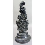 A Victorian cast iron doorstop of shell and c scroll form, 34cm high